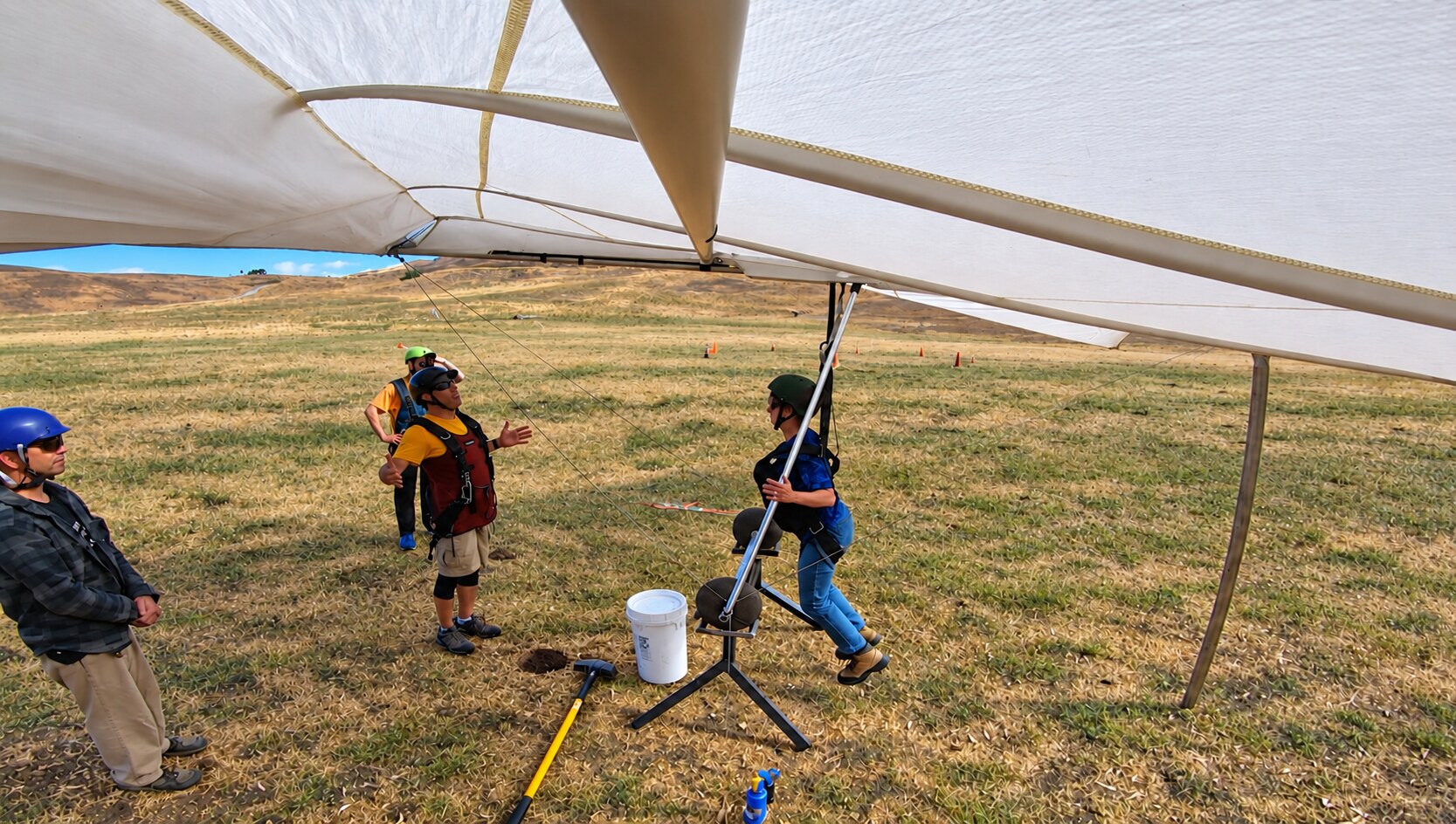 Student practicing hang glider control movements on the training simulator
